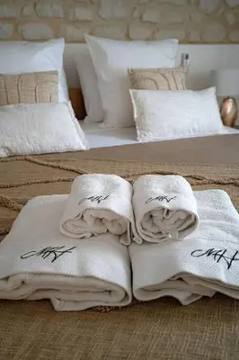 two beds with white towels on top of them at Évasion scandinave à Narbonne élégance et confort réunis ! in Narbonne