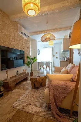 a living room with a couch and a table at Évasion scandinave à Narbonne élégance et confort réunis ! in Narbonne