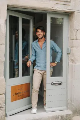 a man standing inside of a door at La Demeure de la Cité by Jean Bacou in Carcassonne