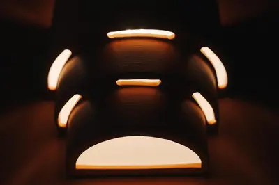 a close up of a toilet seat in a dark room at La Demeure de la Cité by Jean Bacou in Carcassonne