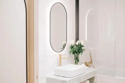 a white bathroom with a sink and mirrors at La Demeure de la Cité by Jean Bacou in Carcassonne