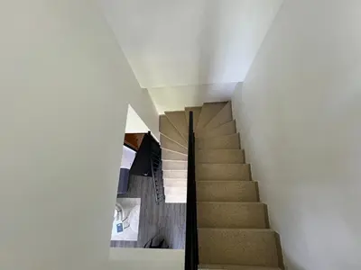 a staircase in a house with white walls at Le Bourgeois Grand T2 in Carcassone