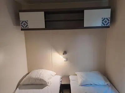 a room with two beds in a room at mobile home 047 in Port-la-Nouvelle