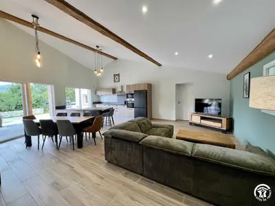 a large living room with a couch and a table at Gite du tatou in Roquefeuil