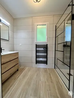 a bathroom with a sink and a glass shower at Gite du tatou in Roquefeuil