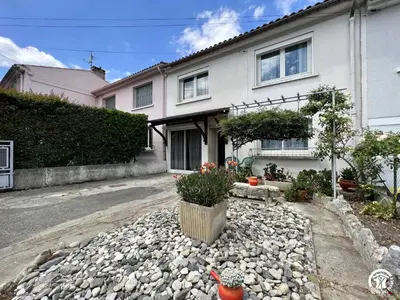 a house with a gravel driveway in front of it at La sapinette in Quillan