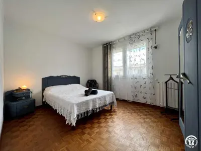 a bedroom with a bed and a large window at La sapinette in Quillan