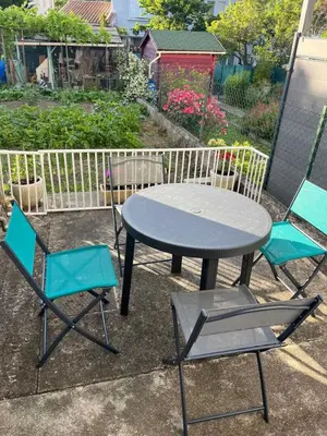 a table and two chairs and a table and chairs at La sapinette in Quillan