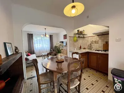 a kitchen and dining room with a table and chairs at La sapinette in Quillan