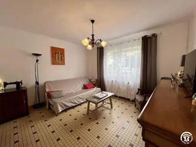 a living room with a couch and a table at La sapinette in Quillan