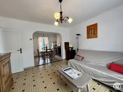 a living room with a couch and a table at La sapinette in Quillan