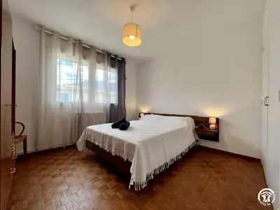 a bedroom with a bed with a cat sitting on it at La sapinette in Quillan