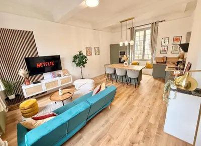 a living room with a blue couch and a table at Luxueux appartement cosy, hypercentre Castres in Castres