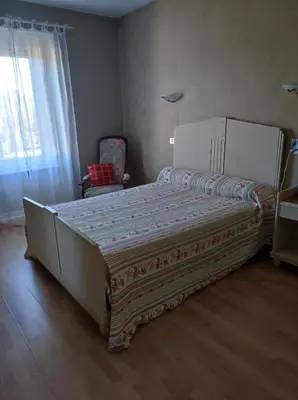 a bedroom with a large bed and a window at Maison vigneronne in Ribaute