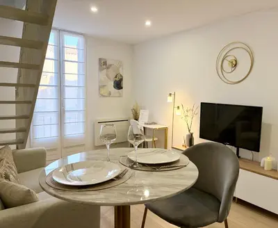 a living room with a couch and a tv at Golden Duplex Chic - Centre-Clim-Parking in Narbonne