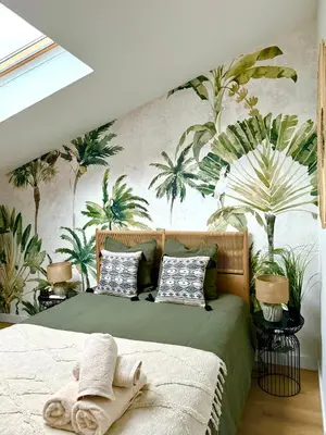 a bedroom with a bed with a mural of palm trees at Golden Duplex Chic - Centre-Clim-Parking in Narbonne