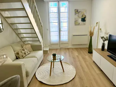 a living room with a couch and a table at Golden Duplex Chic - Centre-Clim-Parking in Narbonne