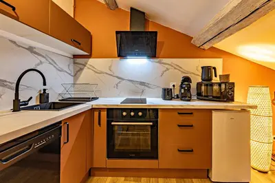 a kitchen with a sink and a stove at TerraCosy 2 personnes - Climatisé, Wifi, proche centre & restaurants in Narbonne
