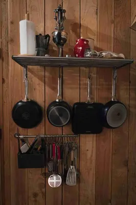 a shelf with pots and pans and utensils on a wall at Fount Estremiero Apartment wellness and pool shared with B&B in Castans