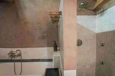a bathroom with a shower and a bath tub at Fount Estremiero Apartment wellness and pool shared with B&B in Castans