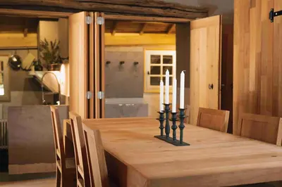 a dining room table with candles on top of it at Fount Estremiero Apartment wellness and pool shared with B&B in Castans