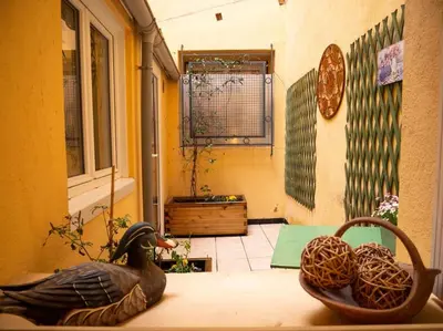 a duck statue on a table with a basket of eggs at Oustal de Papé le calme au cœur de Mirepoix in Mirepoix