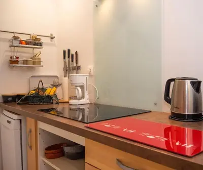 a kitchen with a counter top with a coffee maker at Oustal de Papé le calme au cœur de Mirepoix in Mirepoix