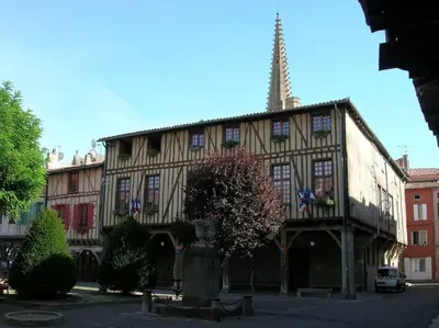 an old building with a tower on top of it at Oustal de Papé le calme au cœur de Mirepoix in Mirepoix