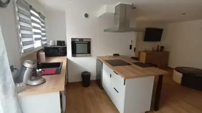 a small kitchen with a counter and a microwave at Appartement calme in Salses-le-Chateau