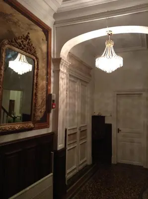 a hallway with a mirror and a chandelier at La Villa Celine in Saint-Laurent-de-la-Cabrerisse