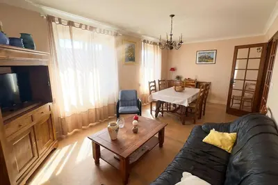 a living room with a couch and a table at Gîte Familial du Vintrou in Le Vintrou