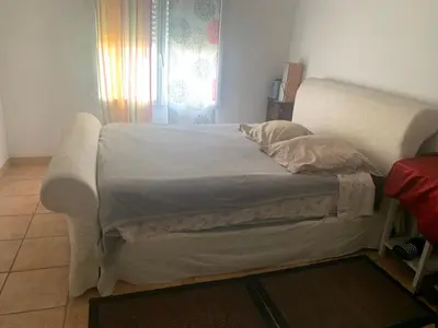 a white bed in a room with a window at Loft cosy in Carcassonne