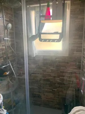 a shower with a glass door and a window at Loft cosy in Carcassonne