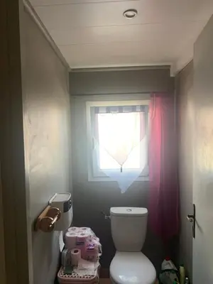 a small bathroom with a toilet and a window at Loft cosy in Carcassonne