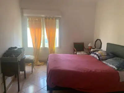 a bedroom with a bed and a window at Loft cosy in Carcassonne