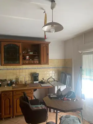 a kitchen with a table and chairs in a room at Loft cosy in Carcassonne