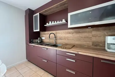 a kitchen with purple cabinets and a sink at Ostau Agradiu - Maison de maître proche de la Mer in Peyriac-de-Mer
