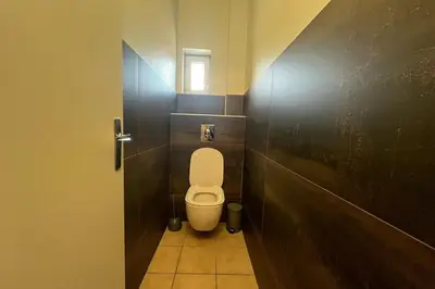 a bathroom with a white toilet in a stall at Ostau Agradiu - Maison de maître proche de la Mer in Peyriac-de-Mer