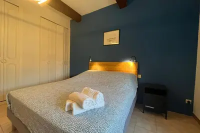 a bedroom with a bed with two towels on it at Ostau Agradiu - Maison de maître proche de la Mer in Peyriac-de-Mer