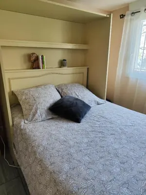 a bedroom with a bed with two pillows on it at Studio Goya climatisé et jardin 2 nuits minimum in Castres