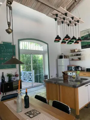 a kitchen with a table and a counter top at Chic trainstation in Pomas