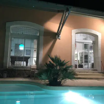 a swimming pool in front of a house at Chic trainstation in Pomas