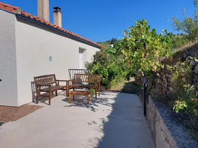 a group of benches sitting on a patio at Villa au calme, tout confort clim piscine wifi 7 personnes in Caunes-Minervois