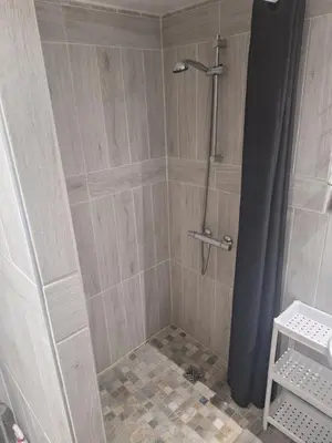 a shower with a shower curtain in a bathroom at Chez Loulou du Linas - Bugarach in Bugarach