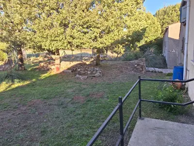 a backyard with a fire pit in the grass at Chez Loulou du Linas - Bugarach in Bugarach