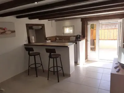 a kitchen with two bar stools and a counter at Chez Loulou du Linas - Bugarach in Bugarach