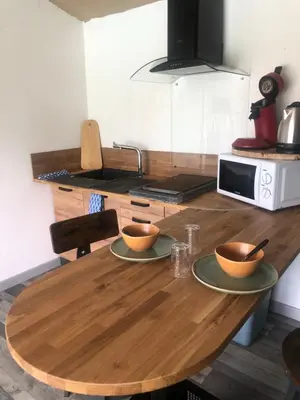 a wooden table with two bowls on it in a kitchen at Chez Anna et JL in Navès
