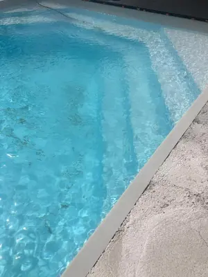 a swimming pool with blue water at Chez Anna et JL in Navès