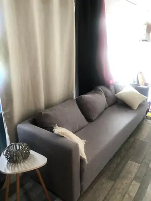 a cat laying on a couch in a living room at Chez Anna et JL in Navès