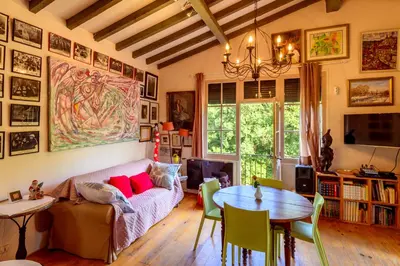 a living room with a couch and a table at Moulin St Pierre bord - Au calme en bord de Rivière in Limoux